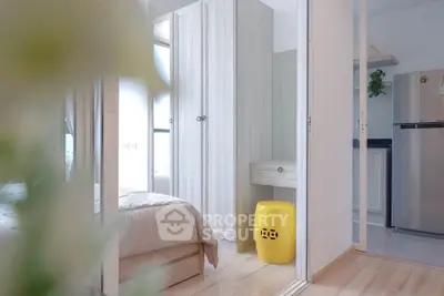 Modern bedroom with light wood flooring and sleek wardrobe design