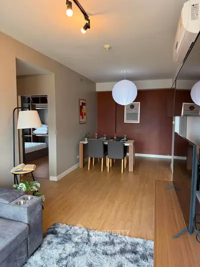 Modern living room with dining area, stylish decor, and cozy ambiance in a contemporary apartment.