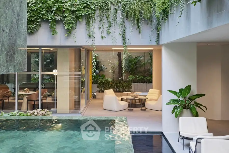 Luxurious modern home with indoor pool and lush greenery, perfect for relaxation and entertaining.