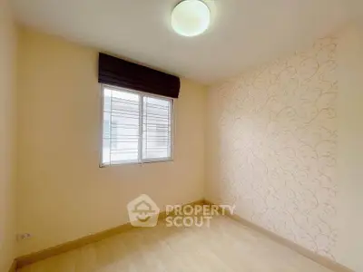 Bright empty room with elegant wallpaper and wooden flooring