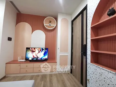 Stylish modern living room with unique wall design and entertainment center.