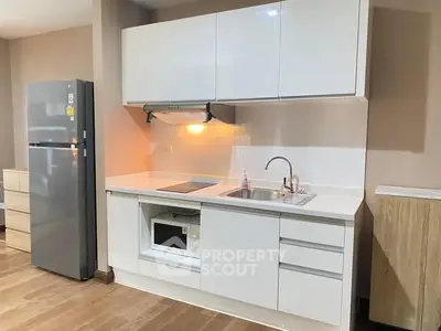 Modern kitchen with sleek white cabinets and built-in appliances