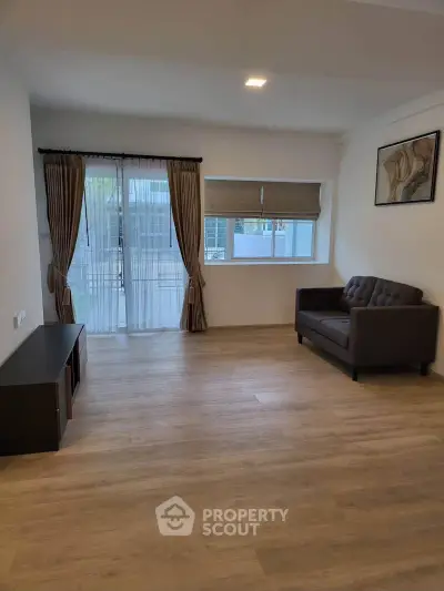 Spacious living room with modern decor and large windows for natural light.