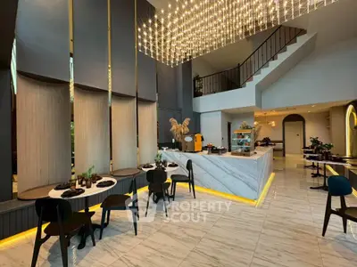 Luxurious modern dining area with high ceilings and elegant lighting in a stylish open-plan layout.