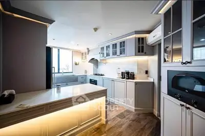 Luxurious modern kitchen with sleek cabinetry and state-of-the-art appliances, perfect for culinary enthusiasts.