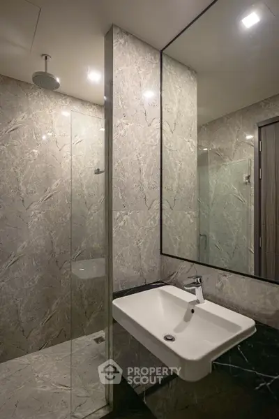 Luxurious modern bathroom with marble walls and sleek fixtures