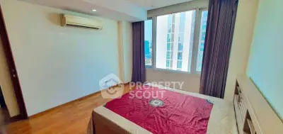 Spacious bedroom with large window and air conditioning in modern apartment