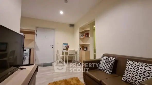 Cozy living room with modern decor and open layout in a stylish apartment.