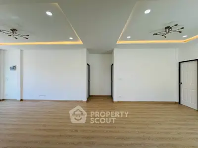 Spacious modern living room with elegant lighting and wooden flooring