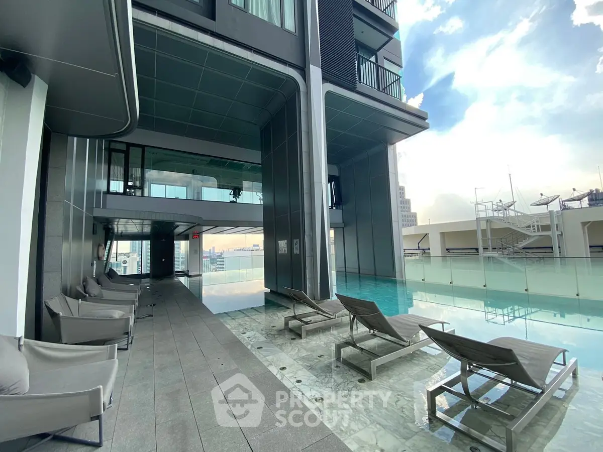 Luxurious rooftop pool with modern lounge chairs and stunning city views.