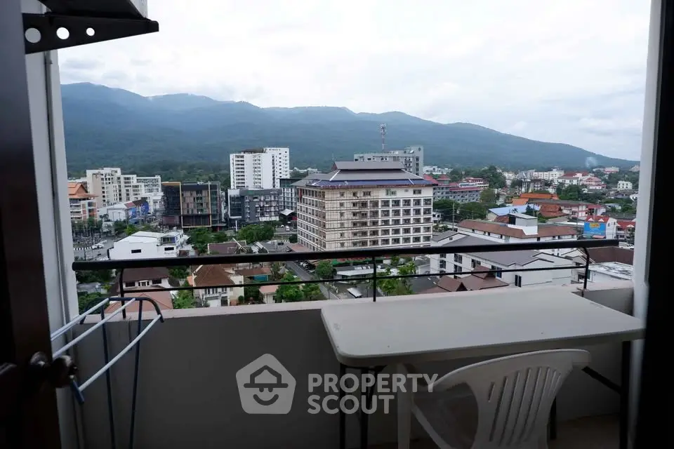 Stunning balcony view of cityscape and mountains, perfect for relaxation and enjoying the scenery.