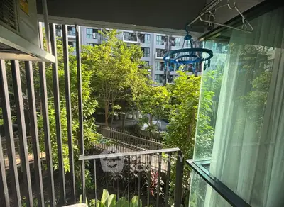 Charming balcony view with lush greenery in modern apartment complex