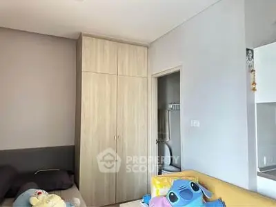 Cozy bedroom with built-in wardrobe and plush toys, perfect for a comfortable living space.