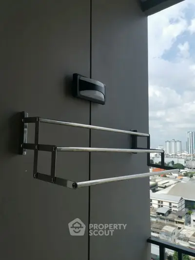 Modern balcony with sleek metal railing and cityscape view, perfect for urban living enthusiasts.