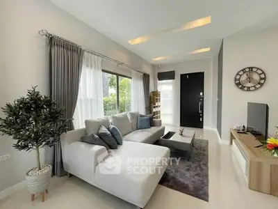 Modern living room with stylish decor and large windows for natural light.