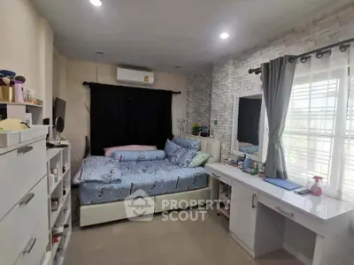 Cozy bedroom with modern decor and ample natural light