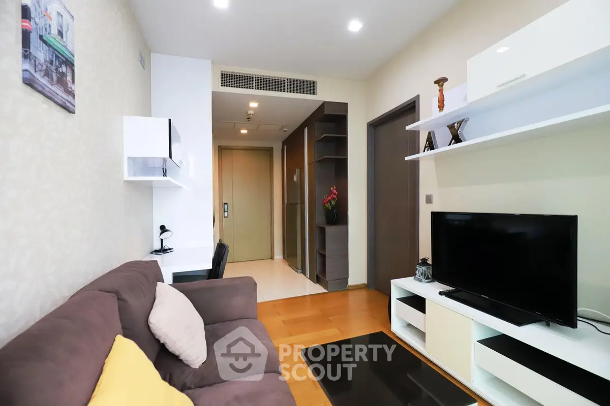 Modern living room with stylish furniture and entertainment center in a cozy apartment.