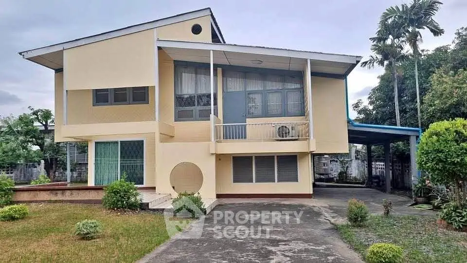 Charming two-story house with spacious driveway and lush greenery, perfect for family living.