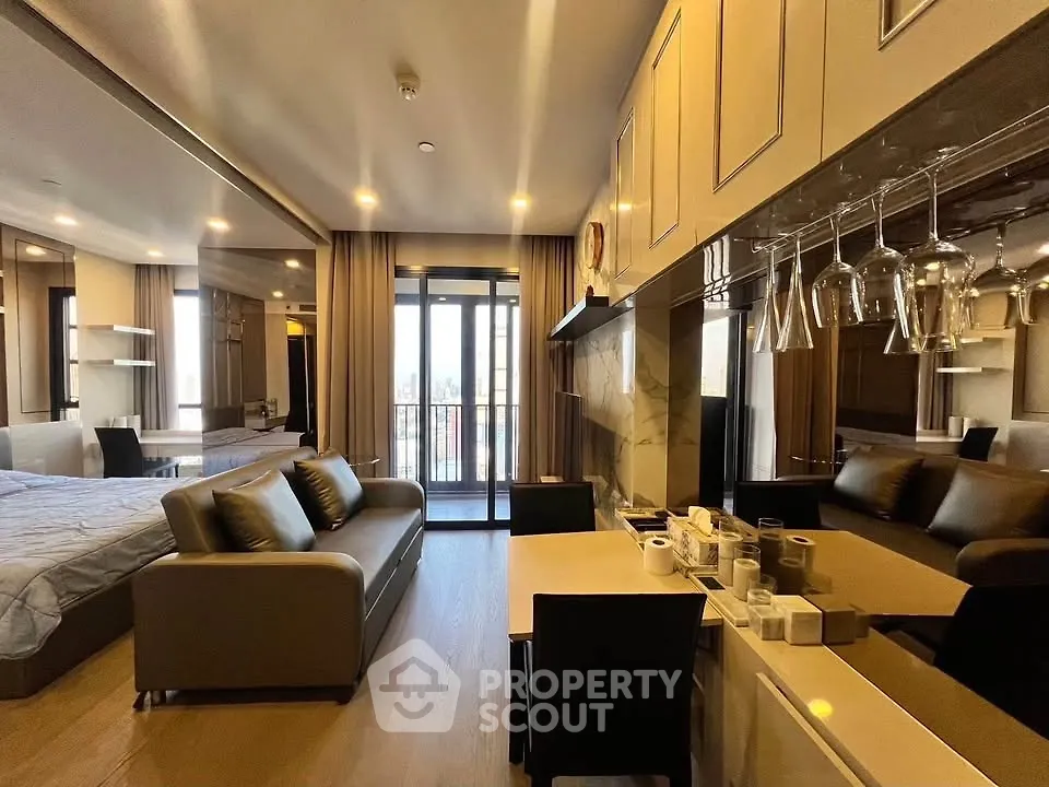 Luxurious open-plan living room with modern kitchen and balcony view