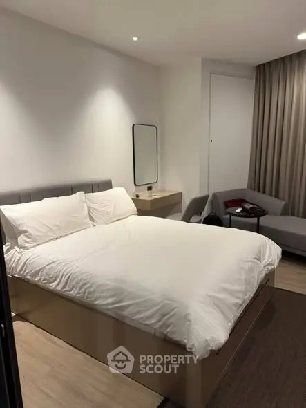 Modern bedroom with cozy bed and stylish decor in a contemporary apartment.
