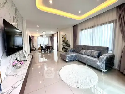 Luxurious modern living room with marble accents and elegant lighting