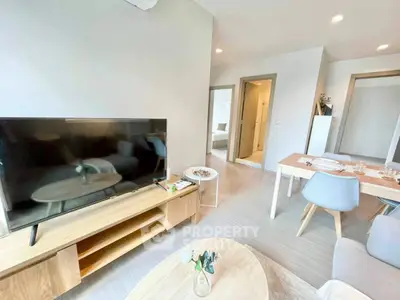 Modern living room with sleek furniture and open dining area, perfect for contemporary living.