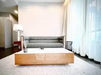 Modern living room with stylish sofa and large windows offering natural light