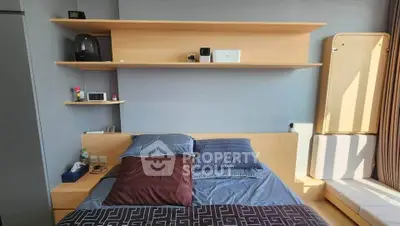 Modern bedroom with sleek wooden shelves and cozy bedding in a stylish apartment.