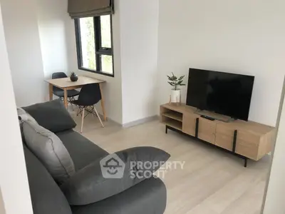 Modern living room with sleek furniture and natural light, perfect for urban living.