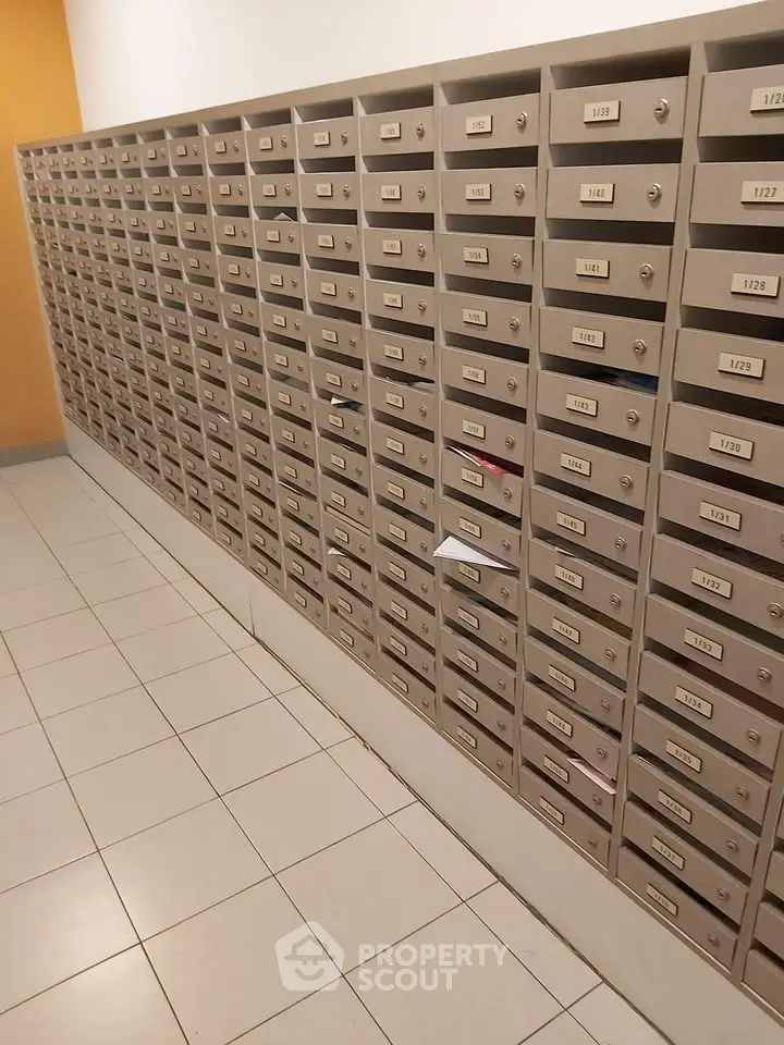 Modern apartment building mailboxes in a tiled hallway