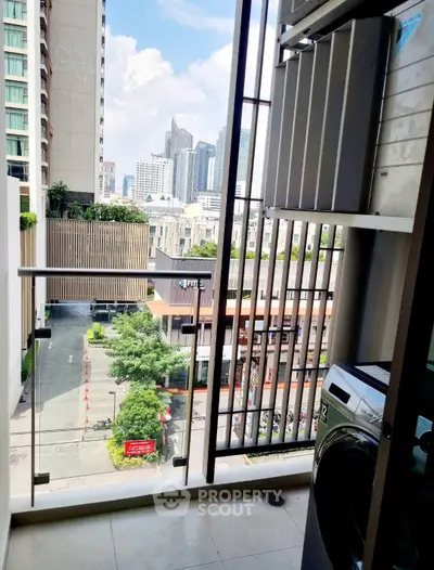 Modern balcony with city view and washing machine in urban apartment