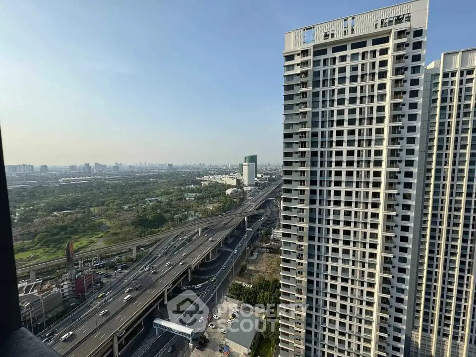 Stunning high-rise building with panoramic city and highway views, perfect for urban living.