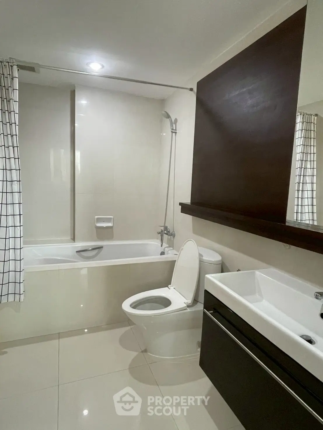 Modern bathroom with sleek fixtures and bathtub in contemporary apartment.