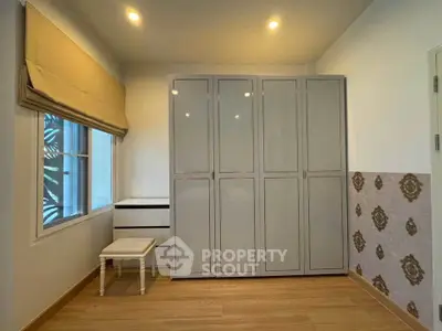 Spacious bedroom with large wardrobe and natural light