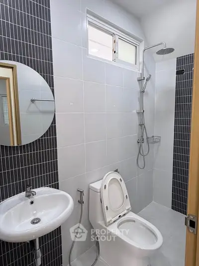Modern bathroom with sleek shower and contemporary fixtures in a stylish real estate property.