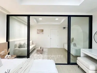 Modern bedroom with glass partition and elegant decor