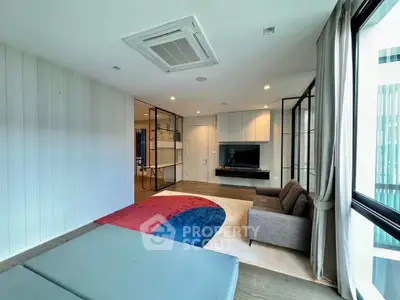 Spacious modern living room with large windows and stylish decor