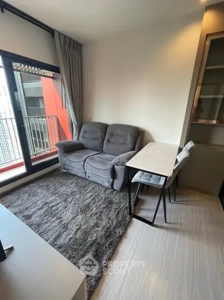 Modern living room with cozy sofa and balcony view in urban apartment