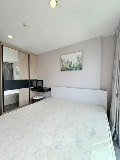 Modern bedroom with large bed, mirrored wardrobe, and stylish decor