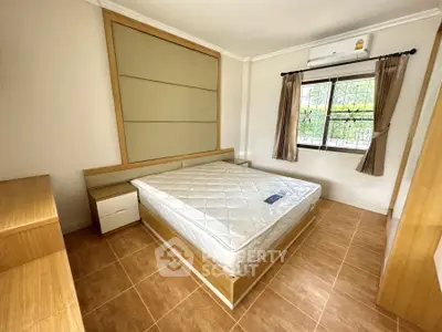 Spacious bedroom with natural light and modern furnishings