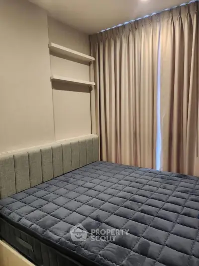 Cozy bedroom with modern design and plush bedding in a stylish apartment.