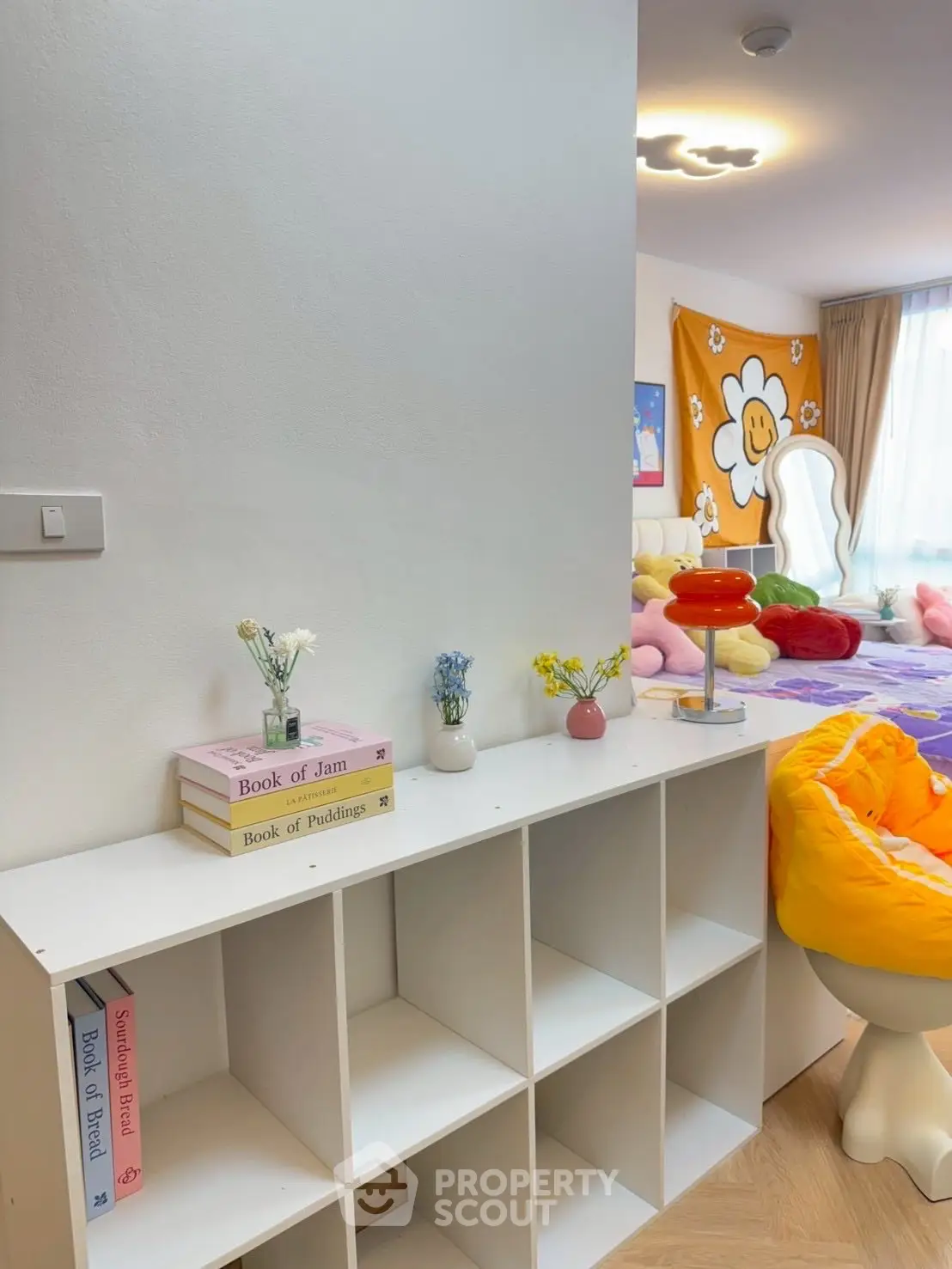 Charming bedroom with colorful decor and modern shelving unit