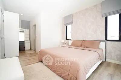 Spacious modern bedroom with stylish decor and natural light