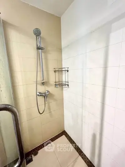 Modern bathroom shower area with sleek fixtures and tiled walls.