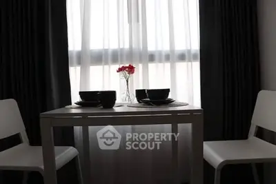 Cozy dining area with elegant table setting by a sunlit window, perfect for intimate meals.