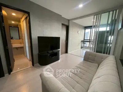 Modern living room with sleek design and balcony view in a stylish apartment.