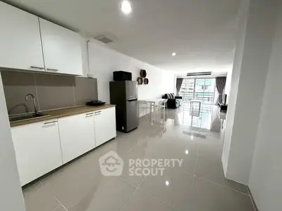 Spacious open-layout kitchen and living area with modern appliances and bright natural light.