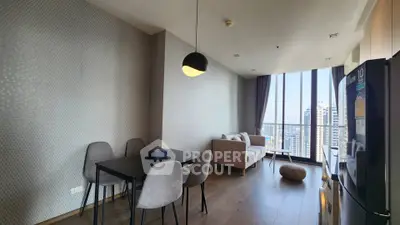 Modern living room with dining area and city view in high-rise apartment