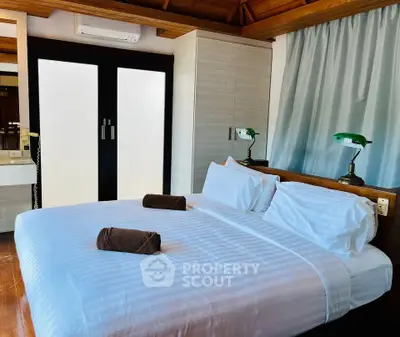 Luxurious bedroom with elegant decor and cozy ambiance, featuring a comfortable bed and stylish lighting.