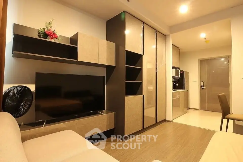 Modern living room with sleek furniture and built-in storage in a cozy apartment.
